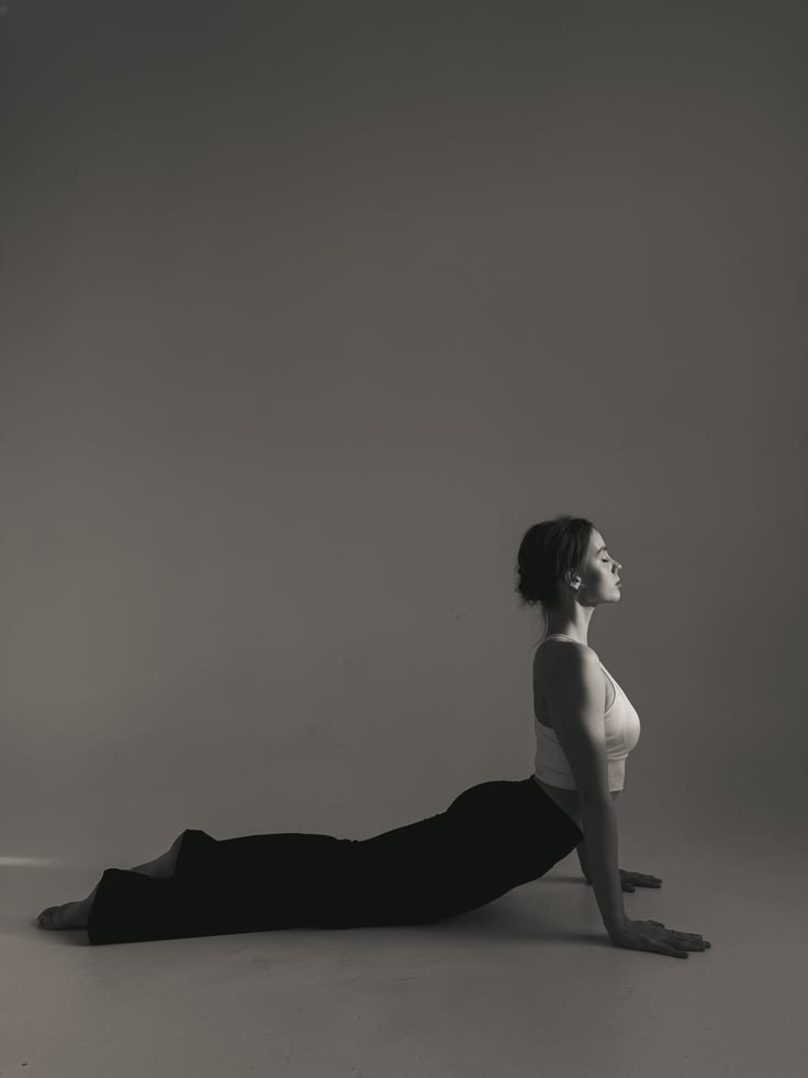 A woman doing a gentle back extension stretch on the floor